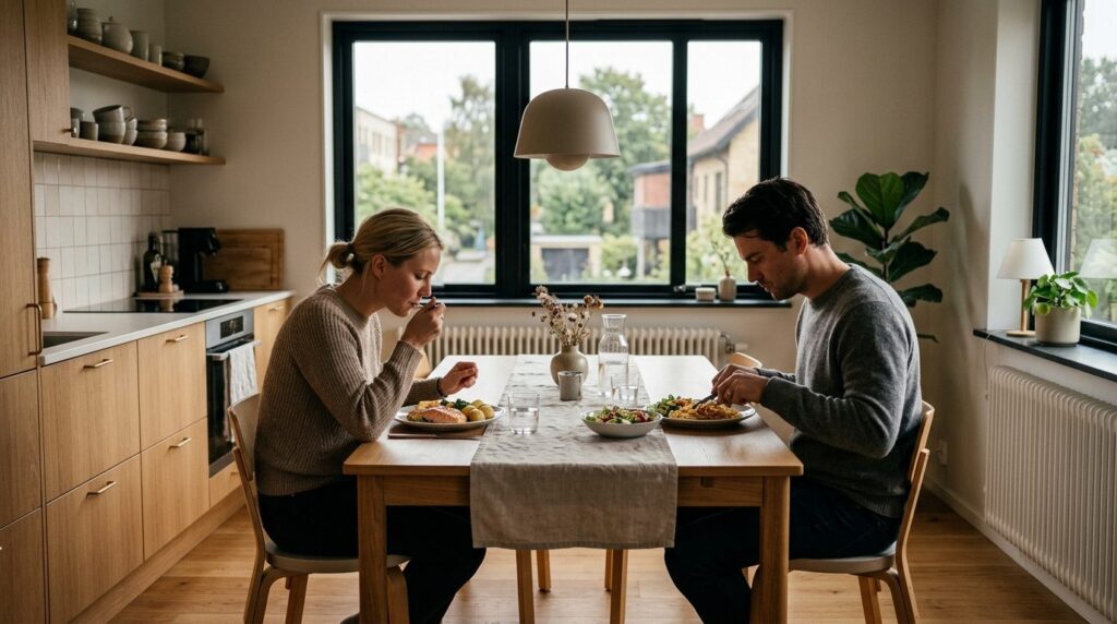 Two people at a dining table in a contemporary Scandinavian 